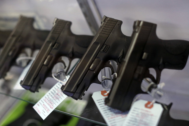 Handguns are seen for sale in a display case at Metro Shooting Supplies in Bridgeton