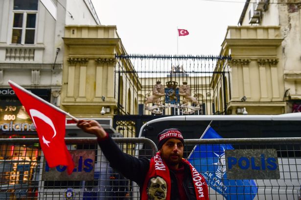 A-man-waves-a-Turkish-flag-in-front-of-t