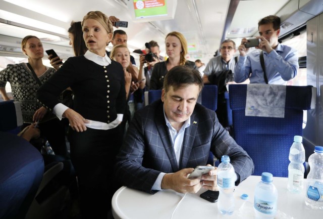 Ukrainian opposition leader Yulia Tymoshenko and former Georgian president Mikheil Saakashvili are seen aboard a train to Lviv after it was cancelled, at a railway station in Przemysl